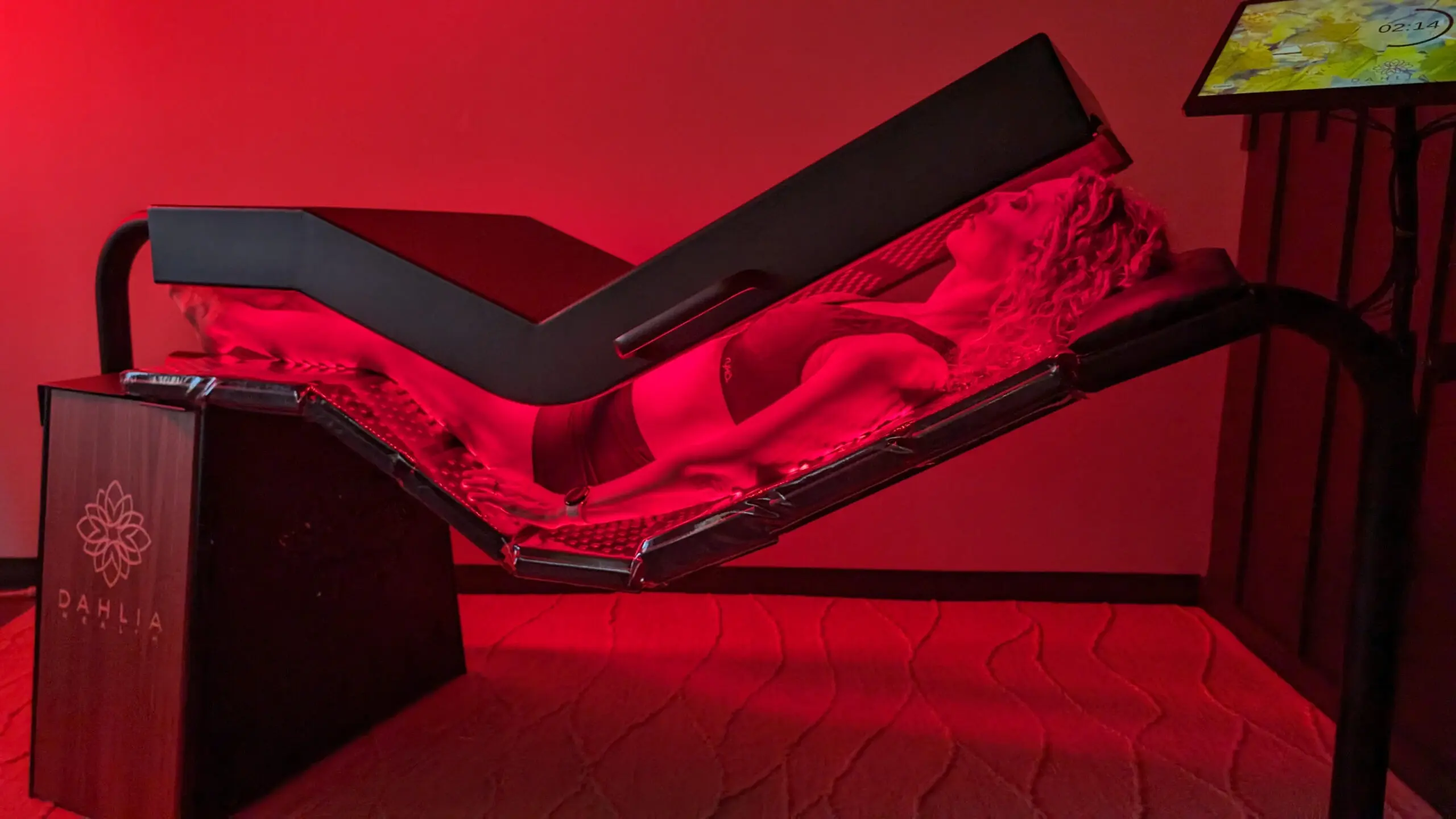 Person lying in a red light therapy bed