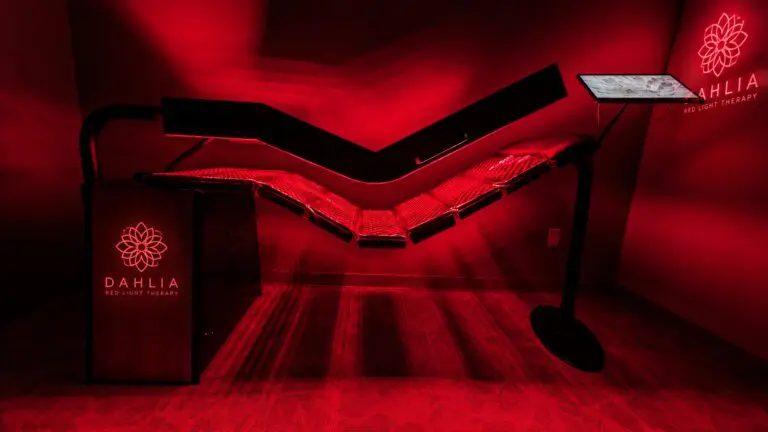 Dahlia red light therapy bed glowing in a treatment room