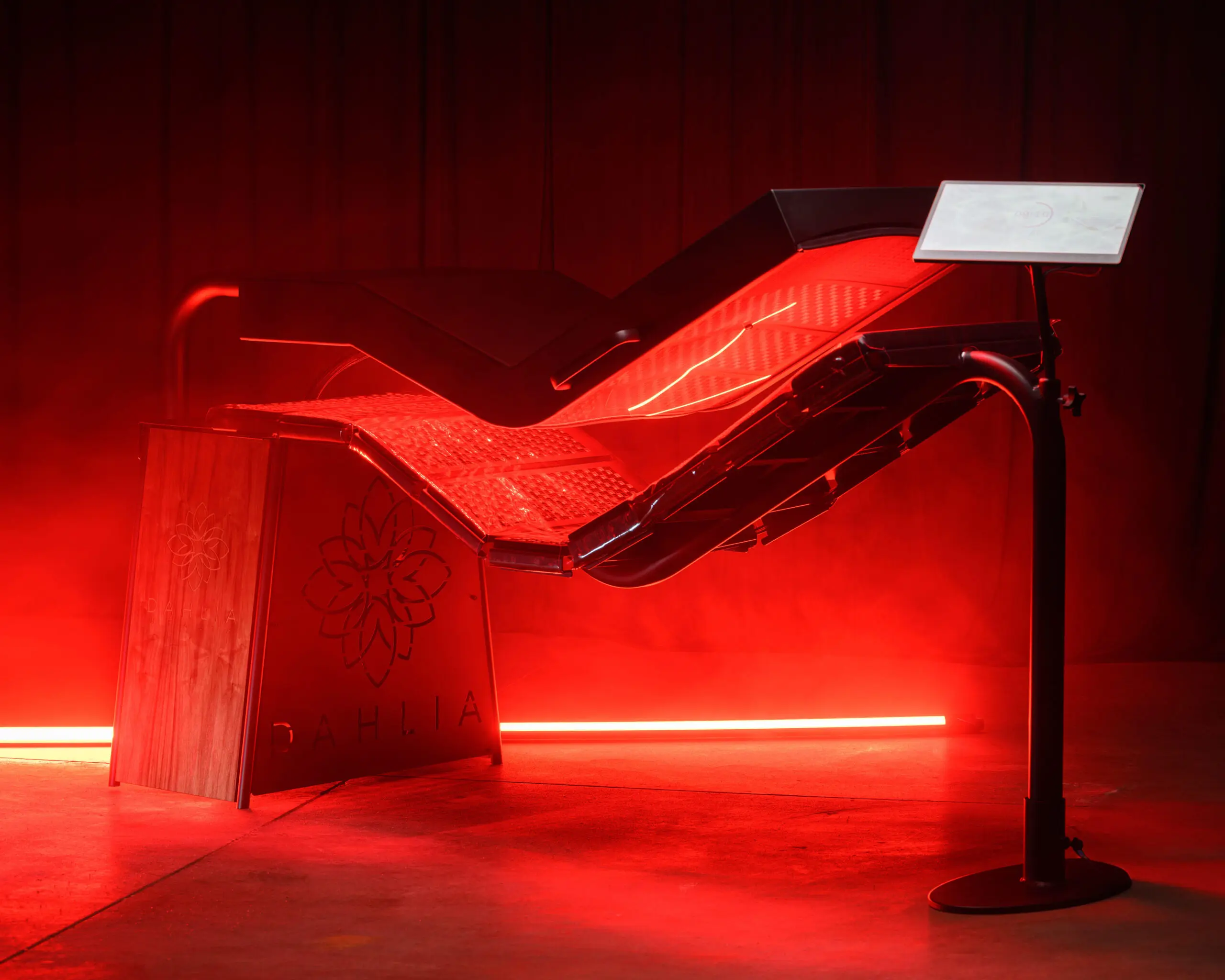 Red light therapy bed glowing under treatment panels