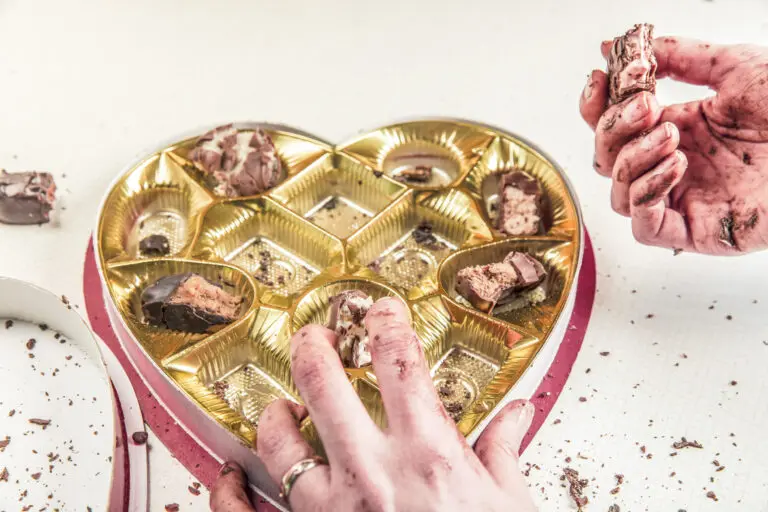 Close-up of a person eating candy and chocolate