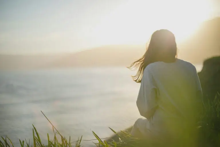 Person sitting calmly practicing deep breathing for wellness