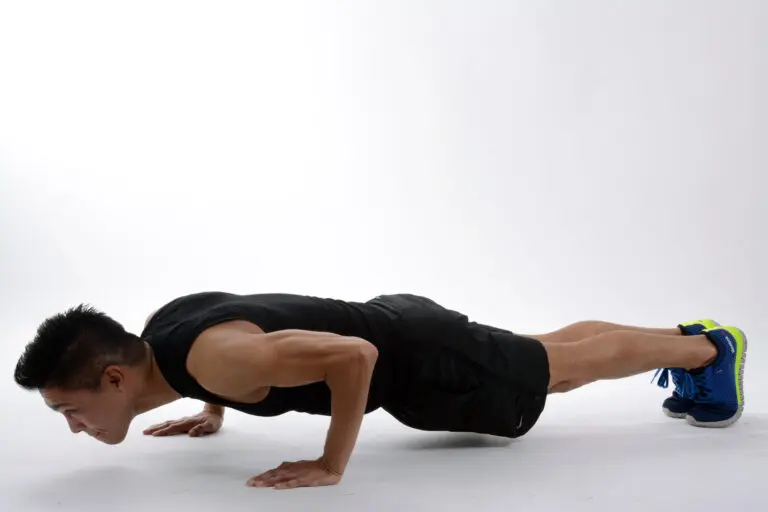 A woman performing a stretching exercise outdoors in a natural setting