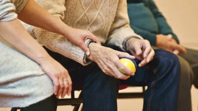Chiropractor performing knee adjustment on patient
