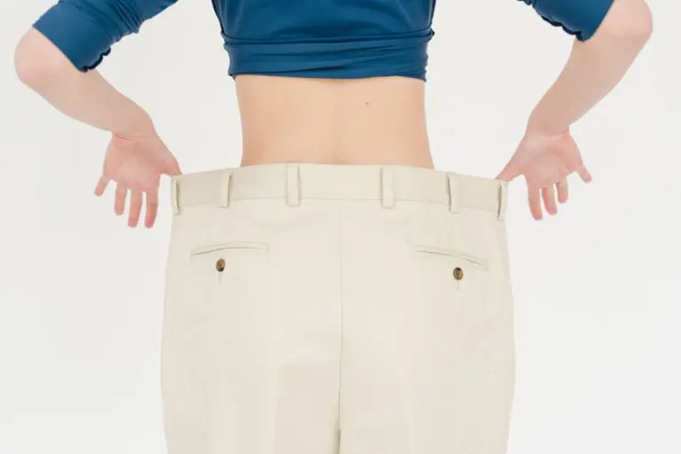 Close-up of person using measuring tape around waist