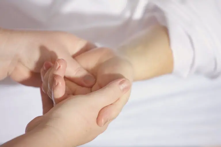 Hand receiving finger treatment to relieve carpal tunnel syndrome and wrist pain