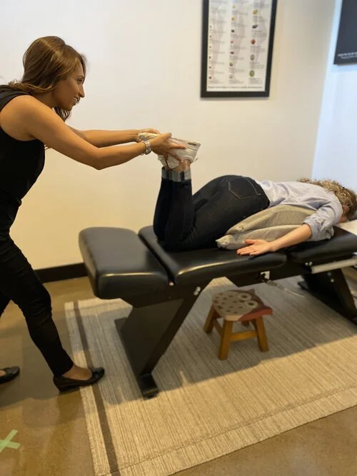 Pregnant woman receiving chiropractic care in clinic
