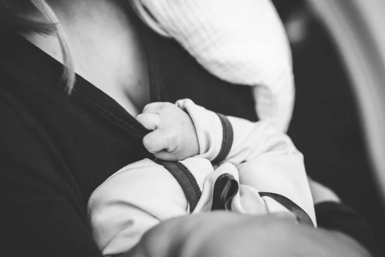 Mother breastfeeding her newborn baby in a calm setting