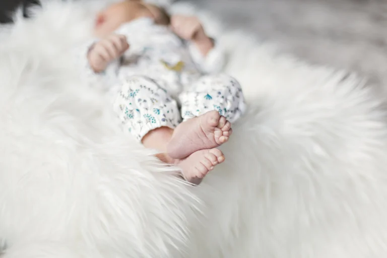 Chiropractor gently adjusting a baby to help soothe and settle