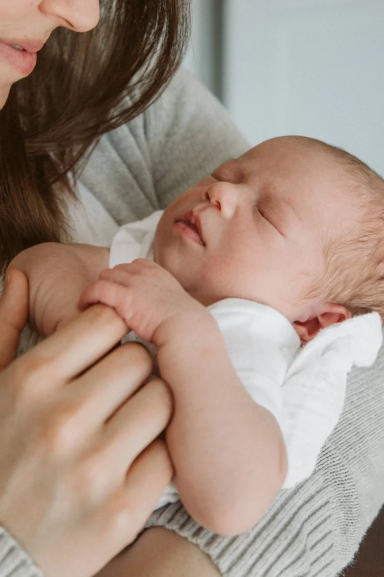 Mother gently holding and embracing her child in a warm setting