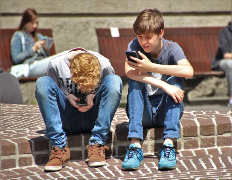 Child playing Pokemon GO game on smartphone outdoors